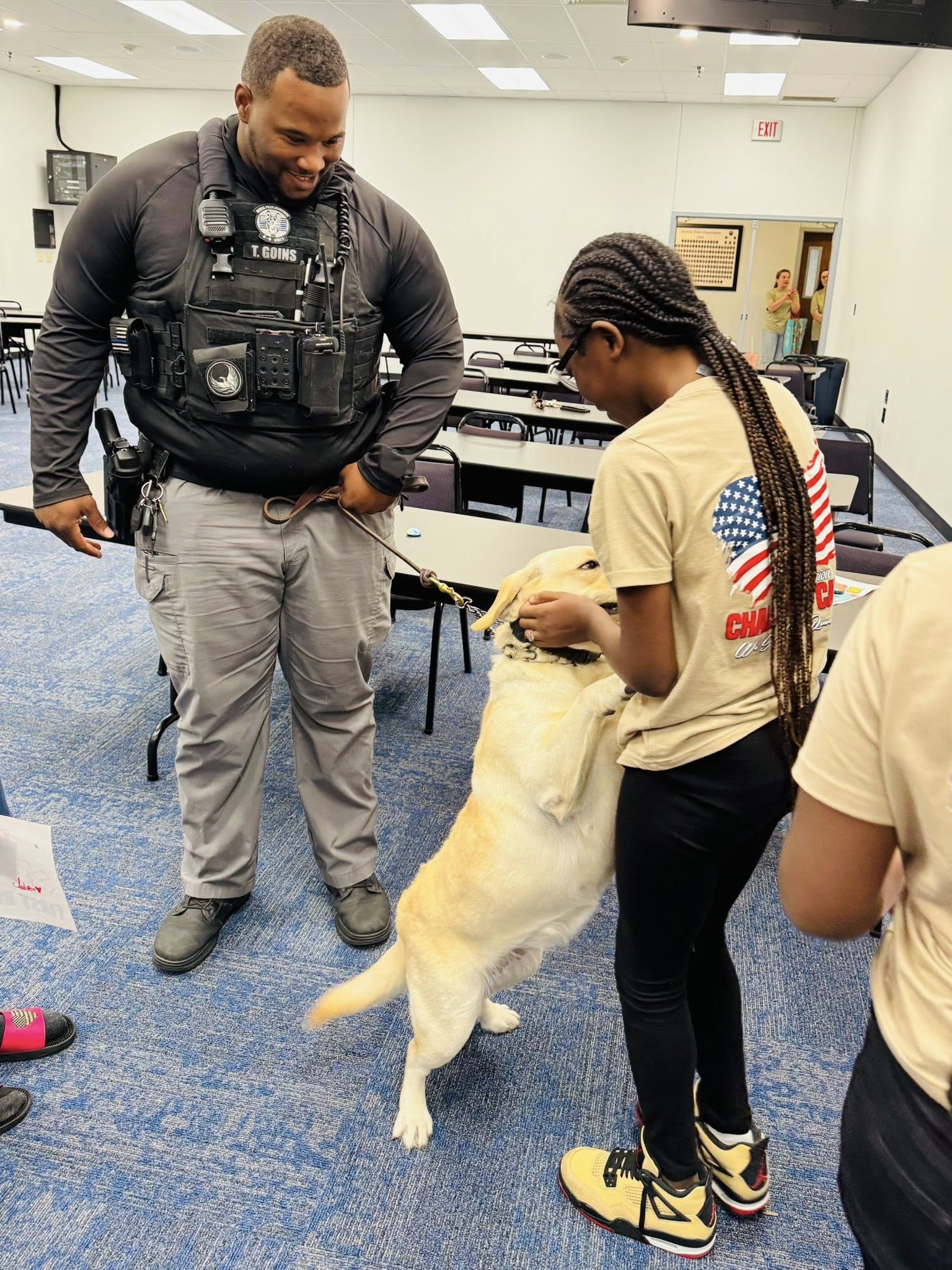 A policeman and his dog with a girl.